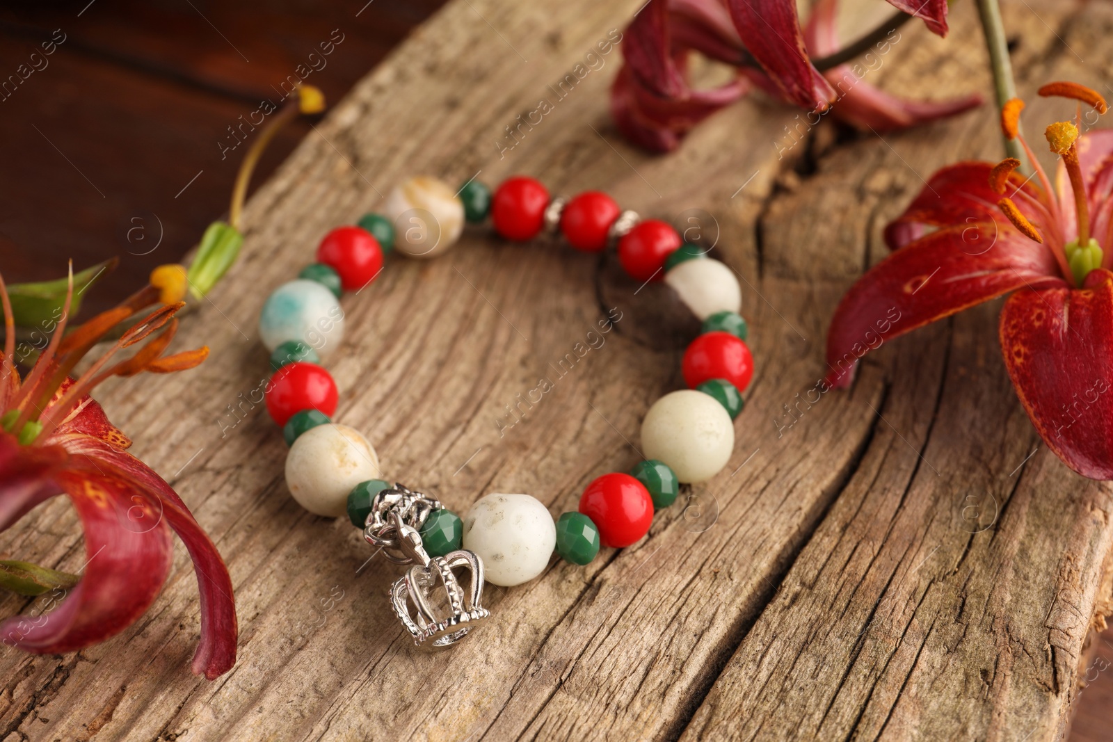 Photo of Stylish presentation of beautiful bracelet with gemstones on table, closeup