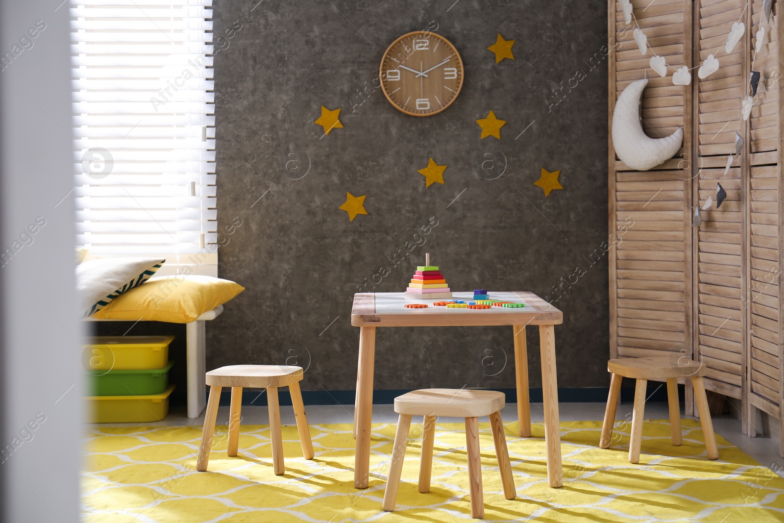 Photo of Baby room interior with wooden furniture and toys