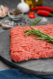 Photo of Raw fresh minced meat with rosemary, closeup