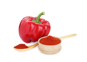 Photo of Bowl, spoon with aromatic paprika powder and fresh bell pepper isolated on white