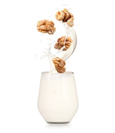 Image of Delicious walnut milk and nuts on white background