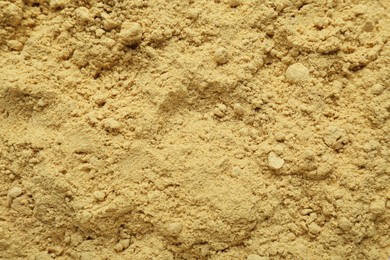 Photo of Aromatic mustard powder as background, top view