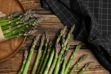 Fresh raw asparagus on wooden table, flat lay