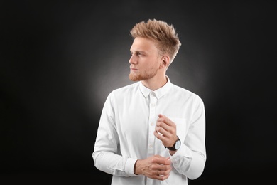 Portrait of handsome young man on dark background