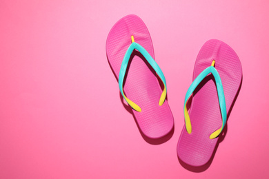 Photo of Pair of stylish flip flops on pink background, top view with space for text. Beach objects