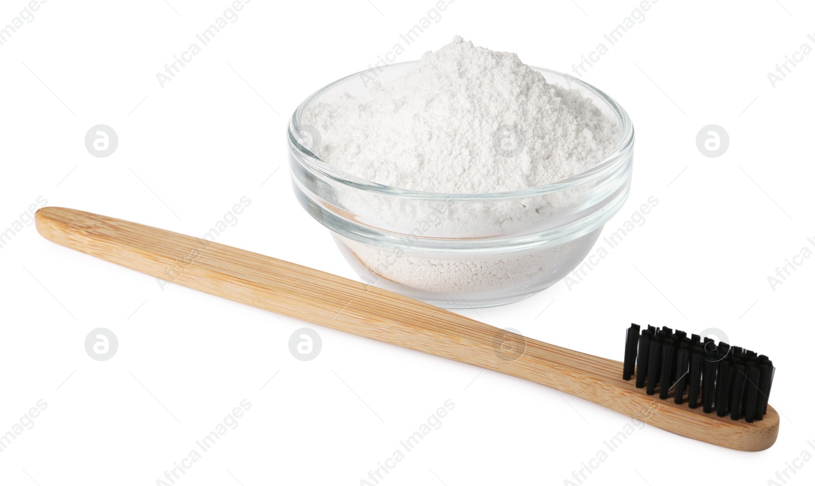 Photo of Glass bowl of tooth powder and brush on white background