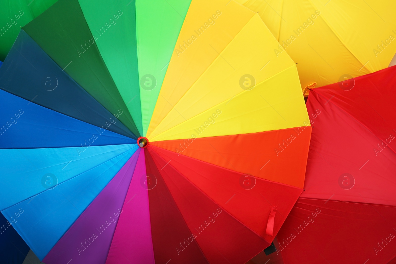 Photo of Many stylish colorful umbrellas as background, closeup