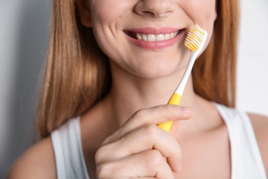 Photo of Smiling woman with toothbrush, closeup. Dental care