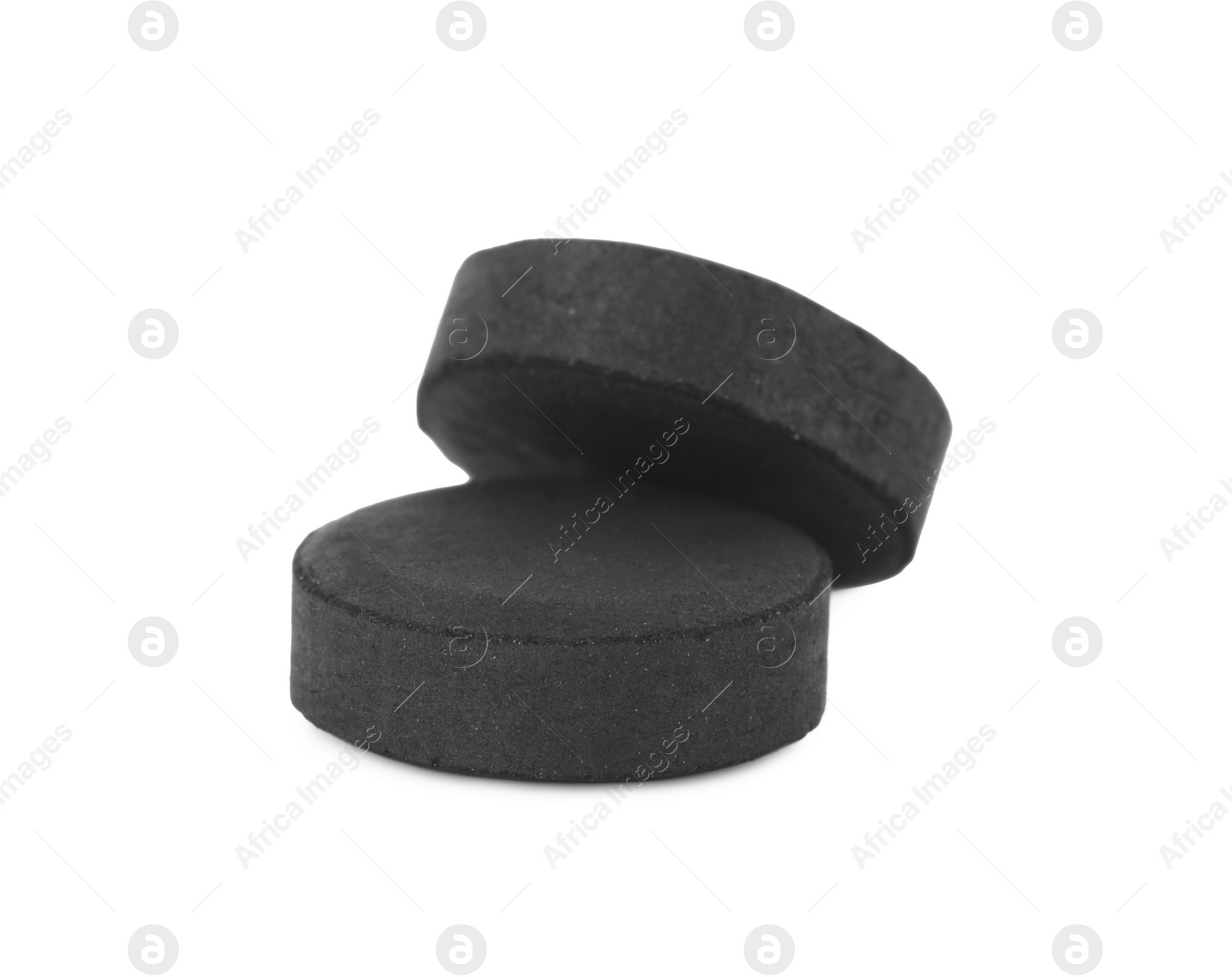 Photo of Activated charcoal pills on white background. Potent sorbent