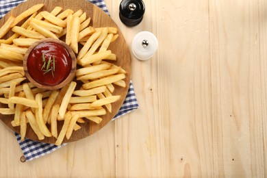 Photo of Delicious french fries served with ketchup on wooden table, flat lay. Space for text