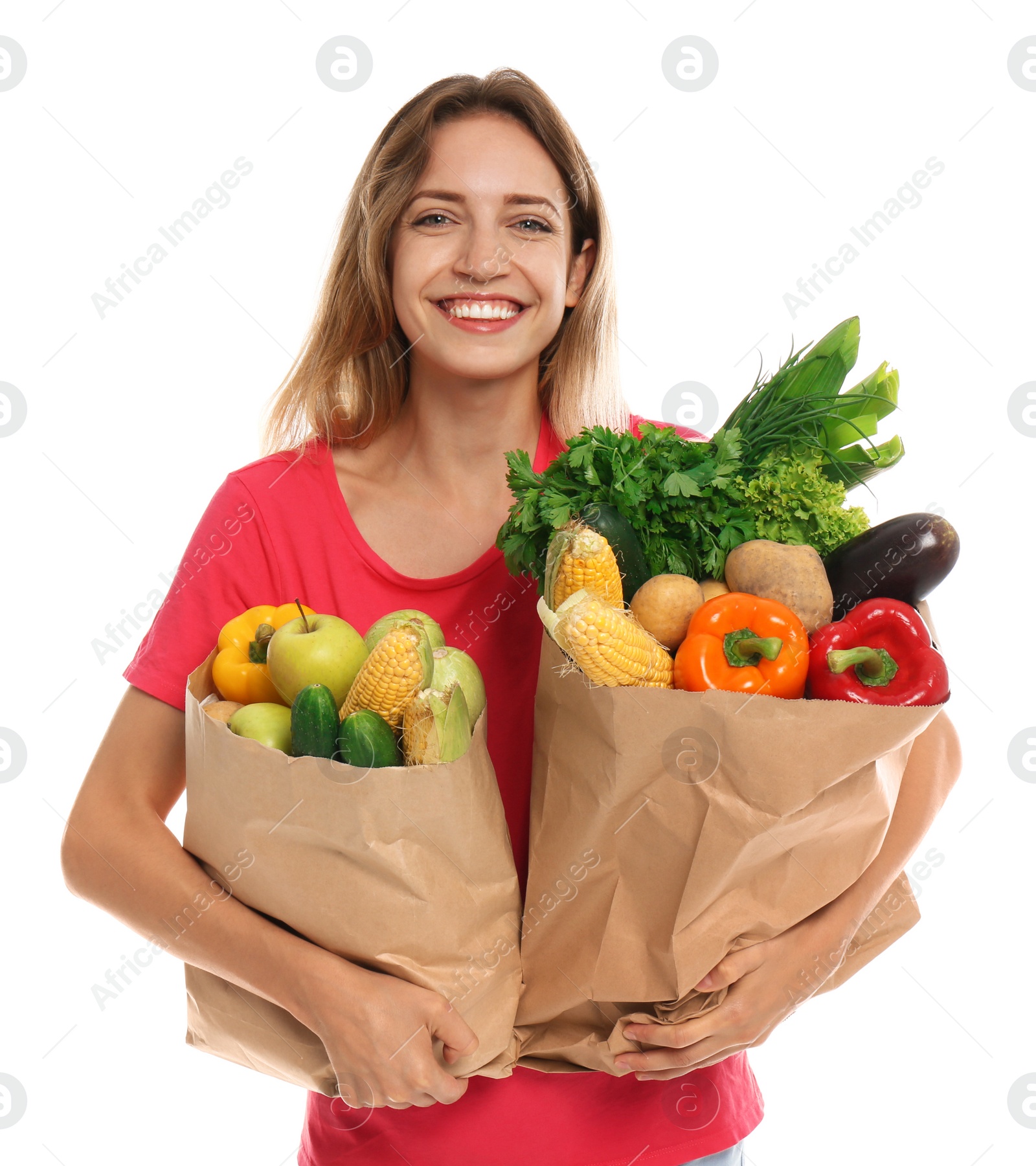 Photo of Young woman with bags of fresh vegetables isolated on white