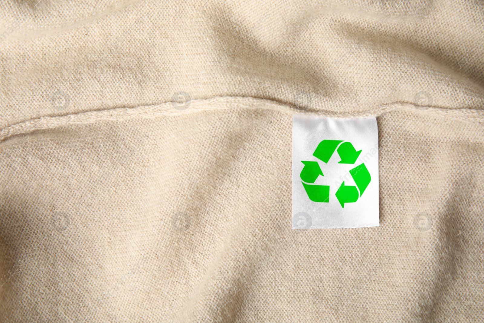 Image of Clothing label with recycling label on cashmere sweater, closeup