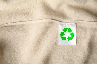 Clothing label with recycling label on cashmere sweater, closeup