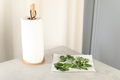 Photo of Mint drying on paper towel on table indoors. Space for text
