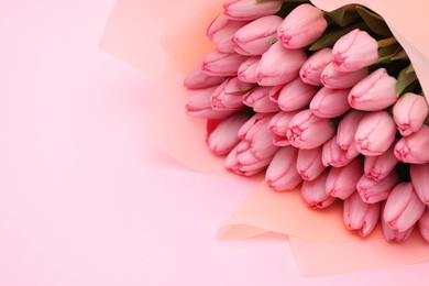 Photo of Bouquet of beautiful tulips on pink background, closeup. Space for text