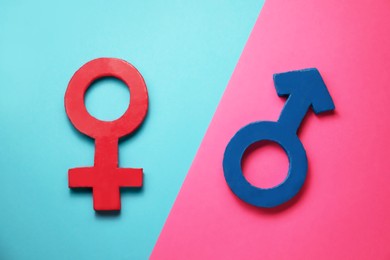 Photo of Gender equality. Male and female symbols on color background, flat lay