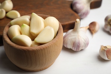 Fresh organic garlic on white table, closeup