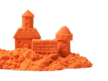Photo of Castle figures made of orange kinetic sand isolated on white