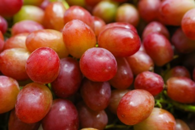 Fresh ripe juicy red grapes as background, closeup view