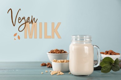 Vegan milk and different nuts on light blue wooden table