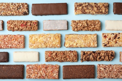 Photo of Flat lay composition with protein bars on color background