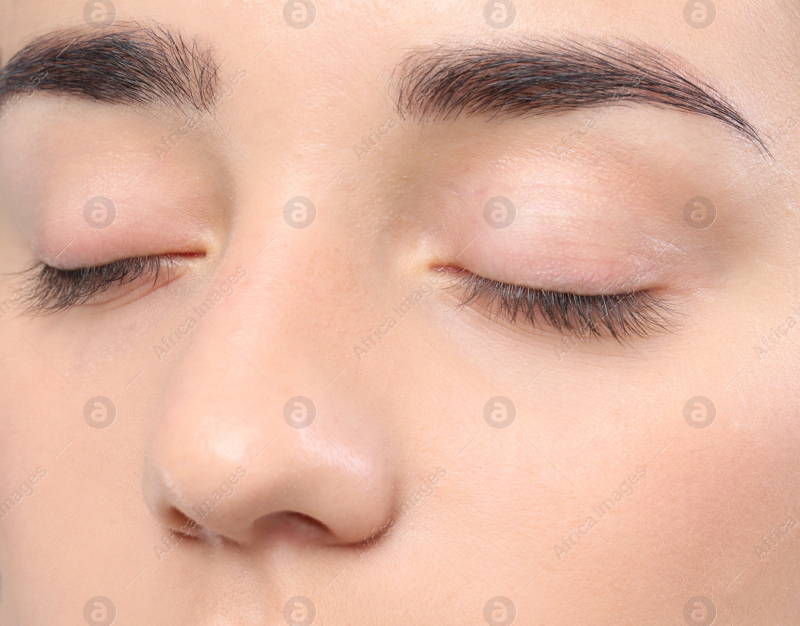 Photo of Young woman with beautiful natural eyelashes, closeup view