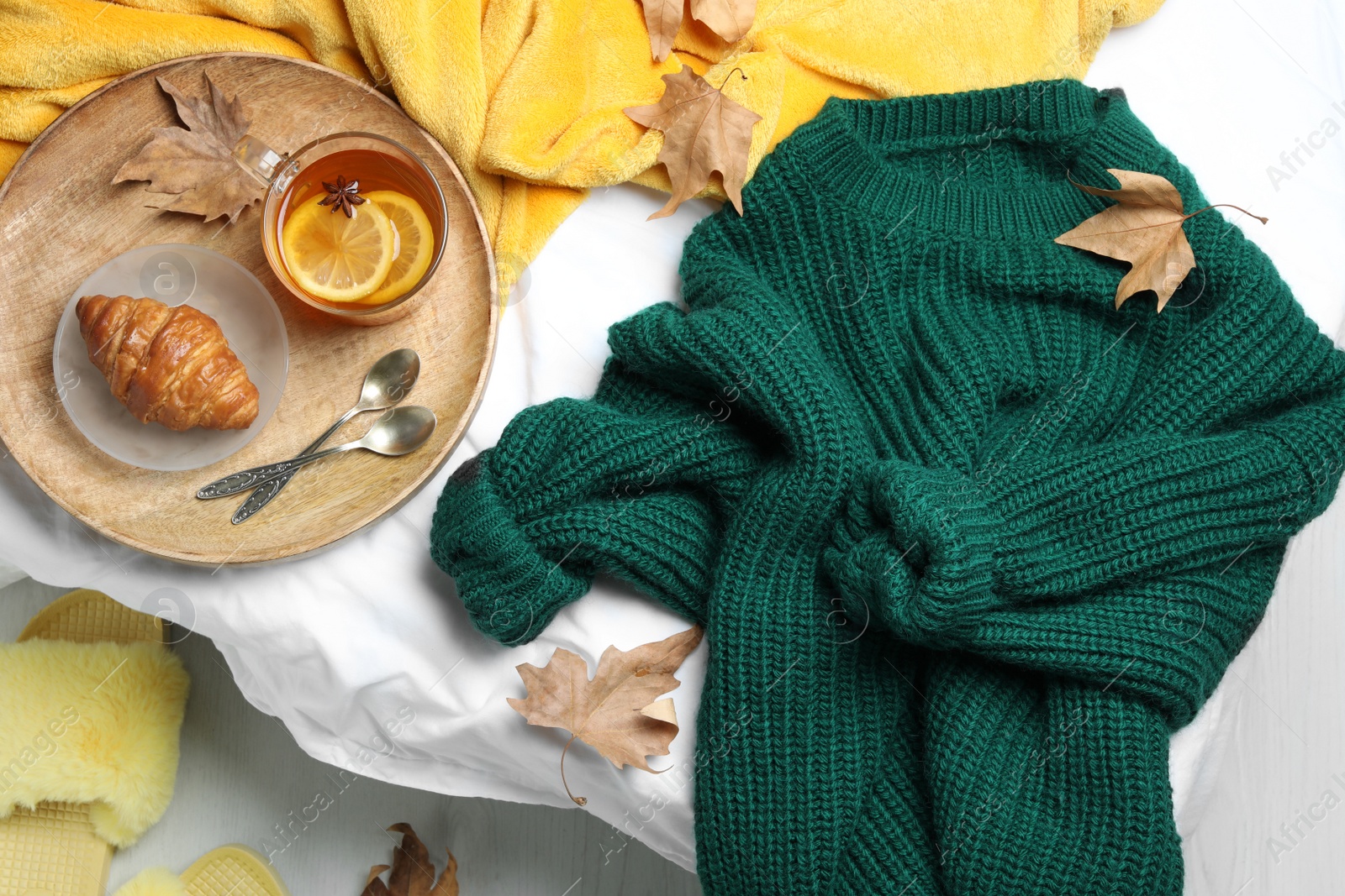 Photo of Knitted sweater and breakfast on bed, flat lay