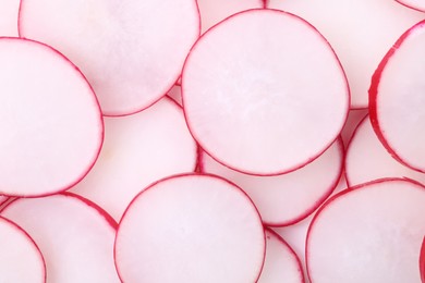 Photo of Slices of fresh ripe radish as background, top view