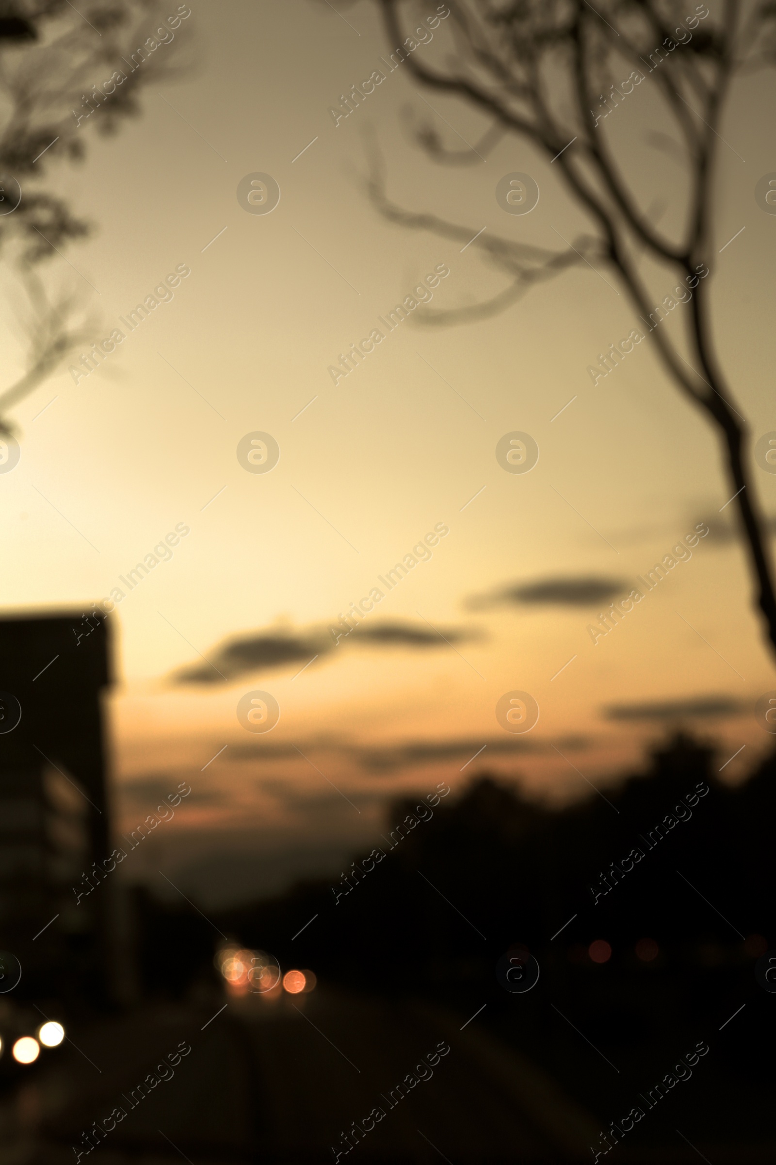 Photo of Blurred view of city and highway with cars at evening
