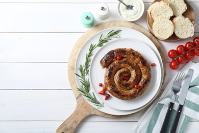 Photo of Tasty homemade sausages served on white wooden table, flat lay. Space for text