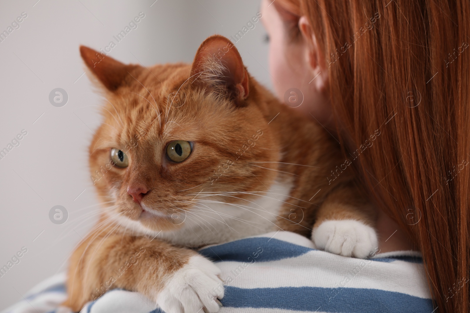 Photo of Woman with her cute cat, closeup view