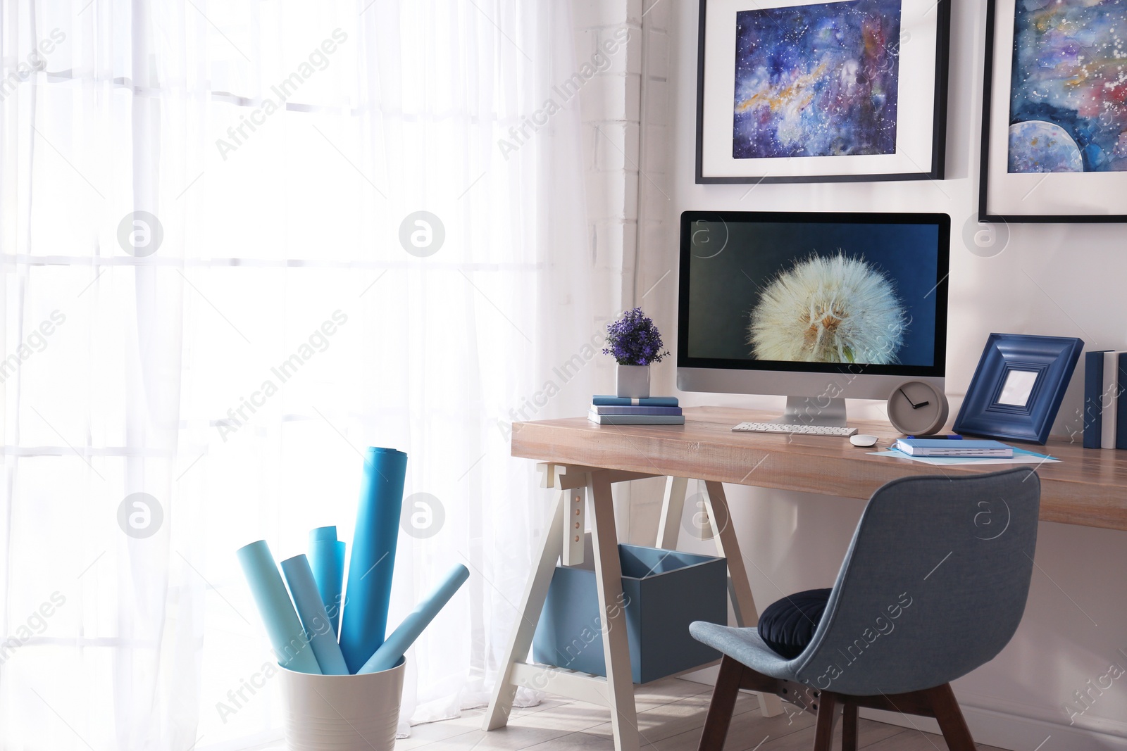 Photo of Modern workplace interior with computer on table