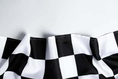 Photo of Checkered finish flag on white background, top view. Space for text