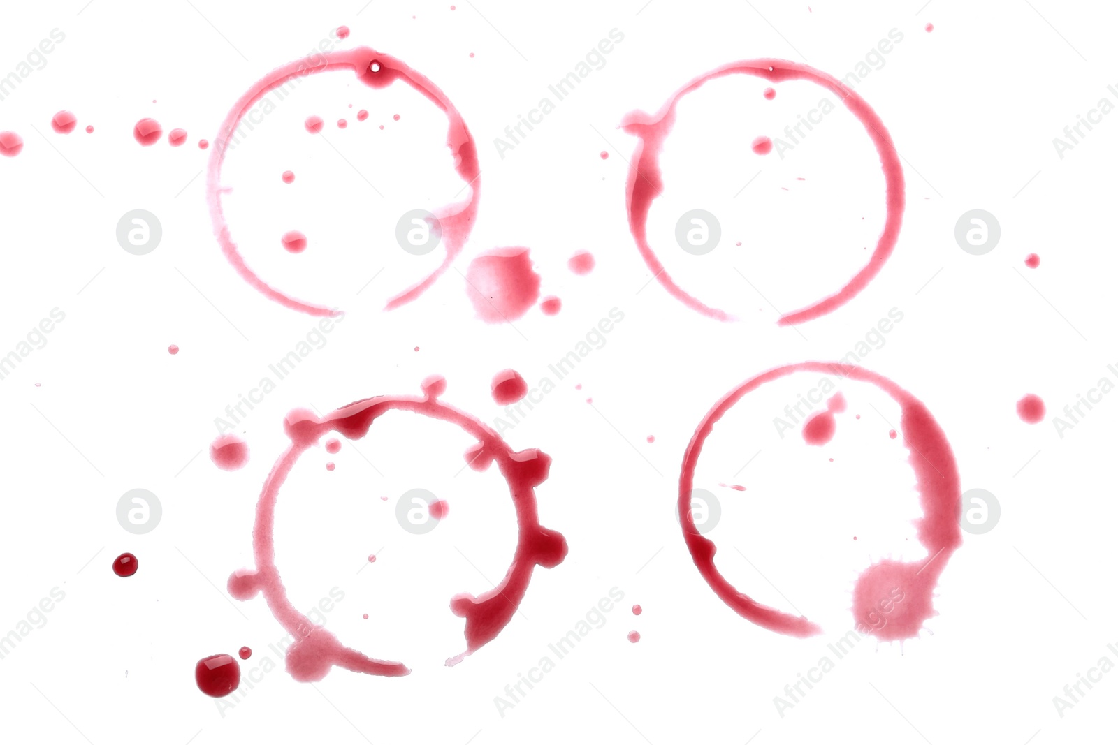 Photo of Red wine rings and drops on white background, top view