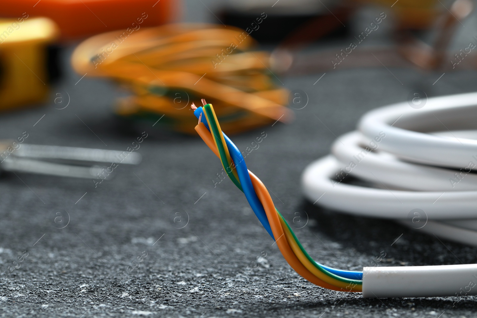 Photo of Electrical wire on black textured table, closeup