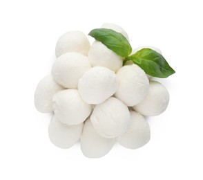 Photo of Pile of mozzarella cheese balls and basil on white background, top view