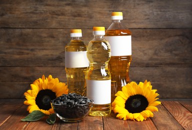 Sunflower cooking oil, seeds and yellow flowers on wooden table