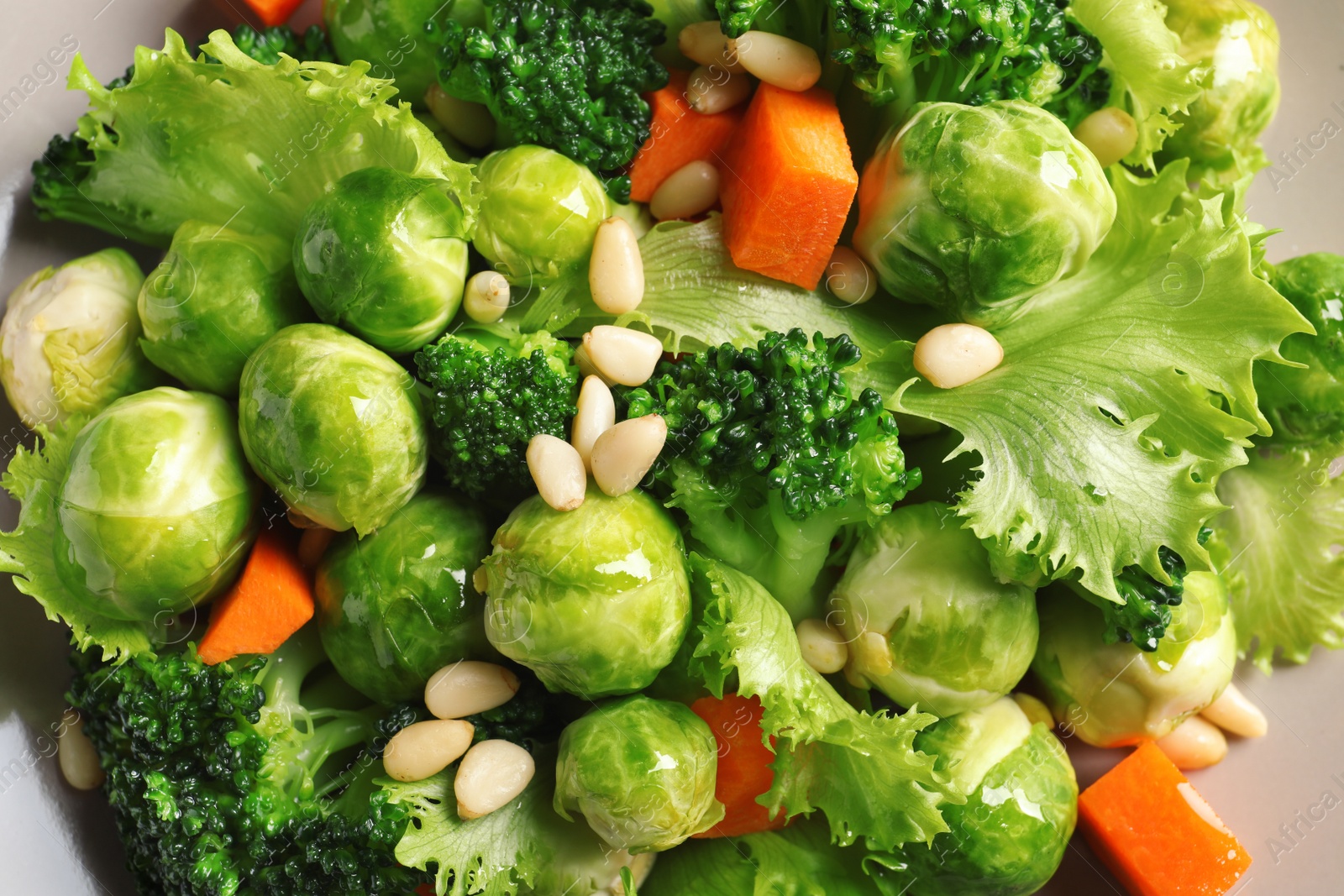 Photo of Plate of salad with Brussels sprouts and pine nuts, closeup