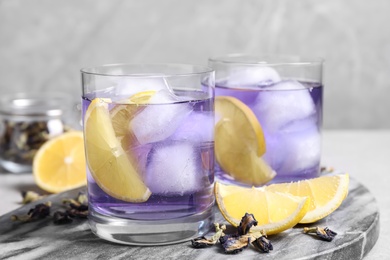 Photo of Organic blue Anchan with lemon on table. Herbal tea