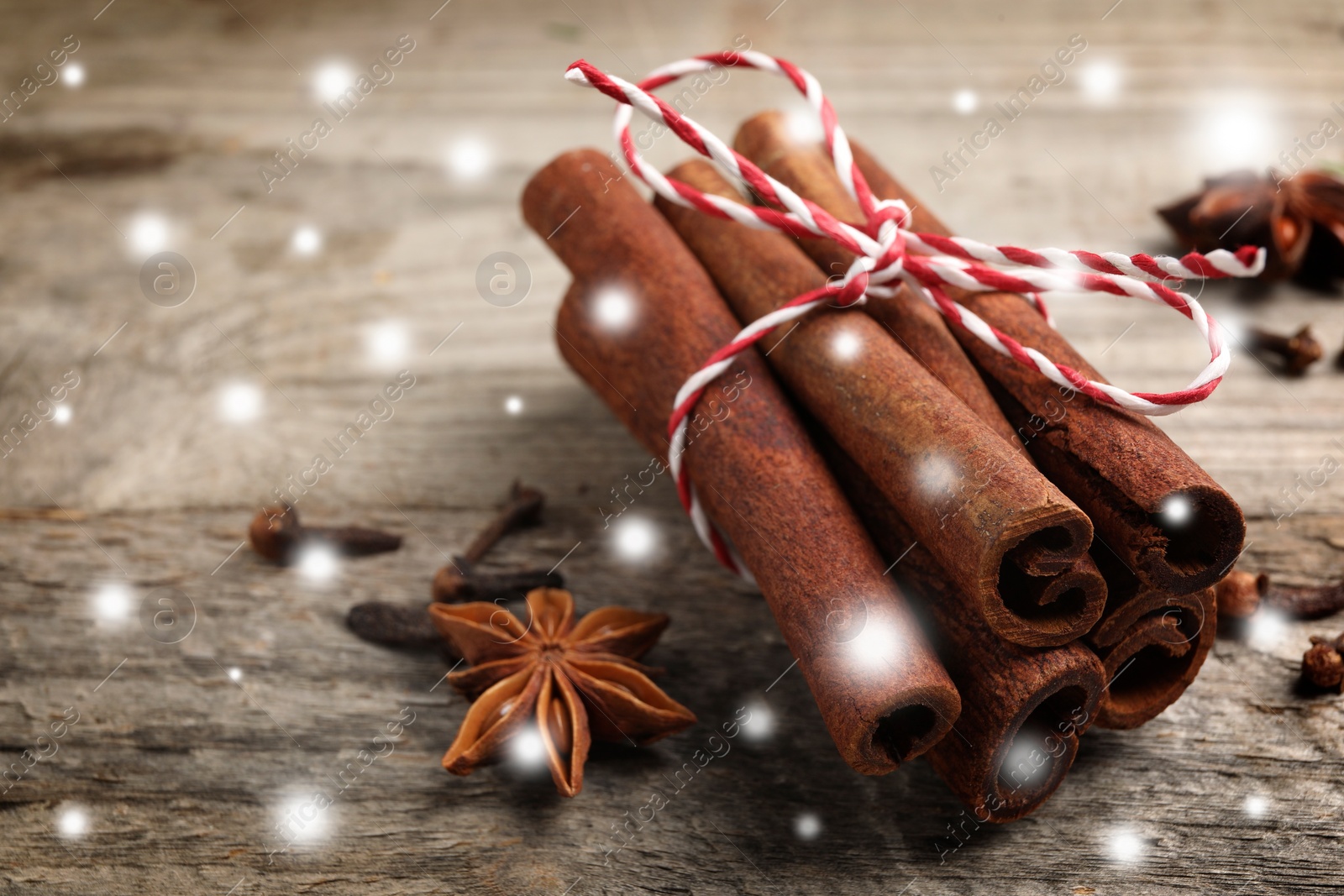 Image of Different spices on wooden table, closeup. Cinnamon, anise, cloves. Space for text