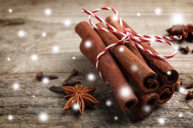 Image of Different spices on wooden table, closeup. Cinnamon, anise, cloves. Space for text