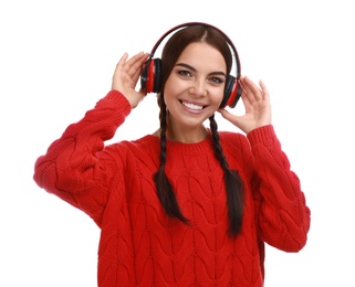 Young woman listening to music with headphones on white background