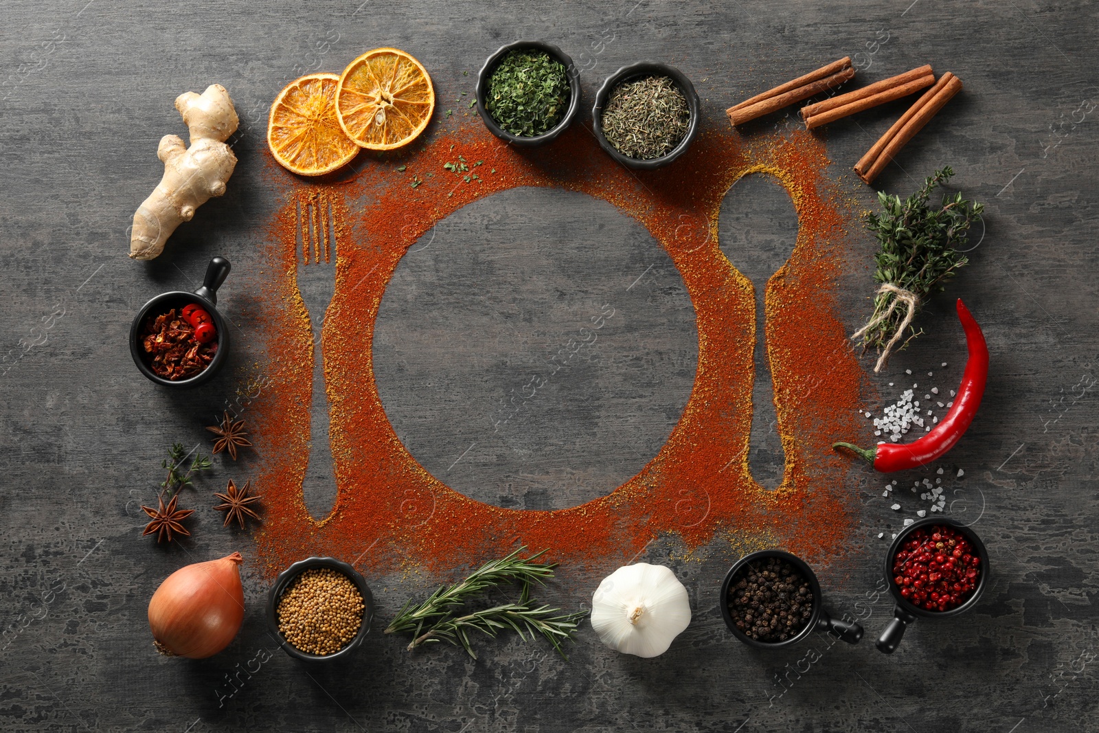 Photo of Flat lay composition with different spices, silhouettes of cutlery and plate on grey table. Space for text