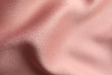 Photo of Texture of pink silk fabric as background, closeup