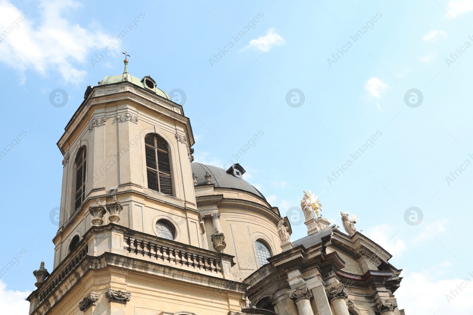 Photo of Exterior of beautiful cathedral against blue sky, low angle view