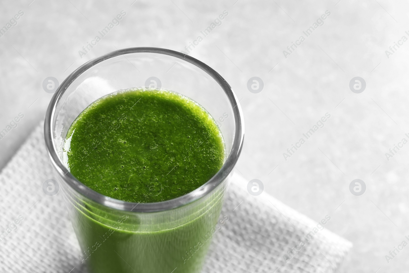 Photo of Glass with delicious detox juice on table, closeup