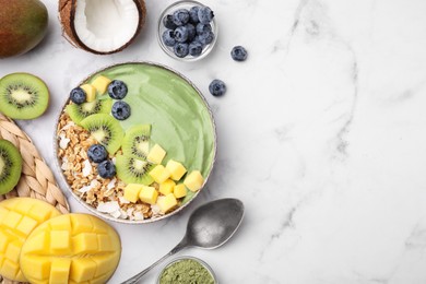 Photo of Tasty matcha smoothie bowl with fresh fruits and oatmeal served on white marble table, flat lay with space for text. Healthy breakfast