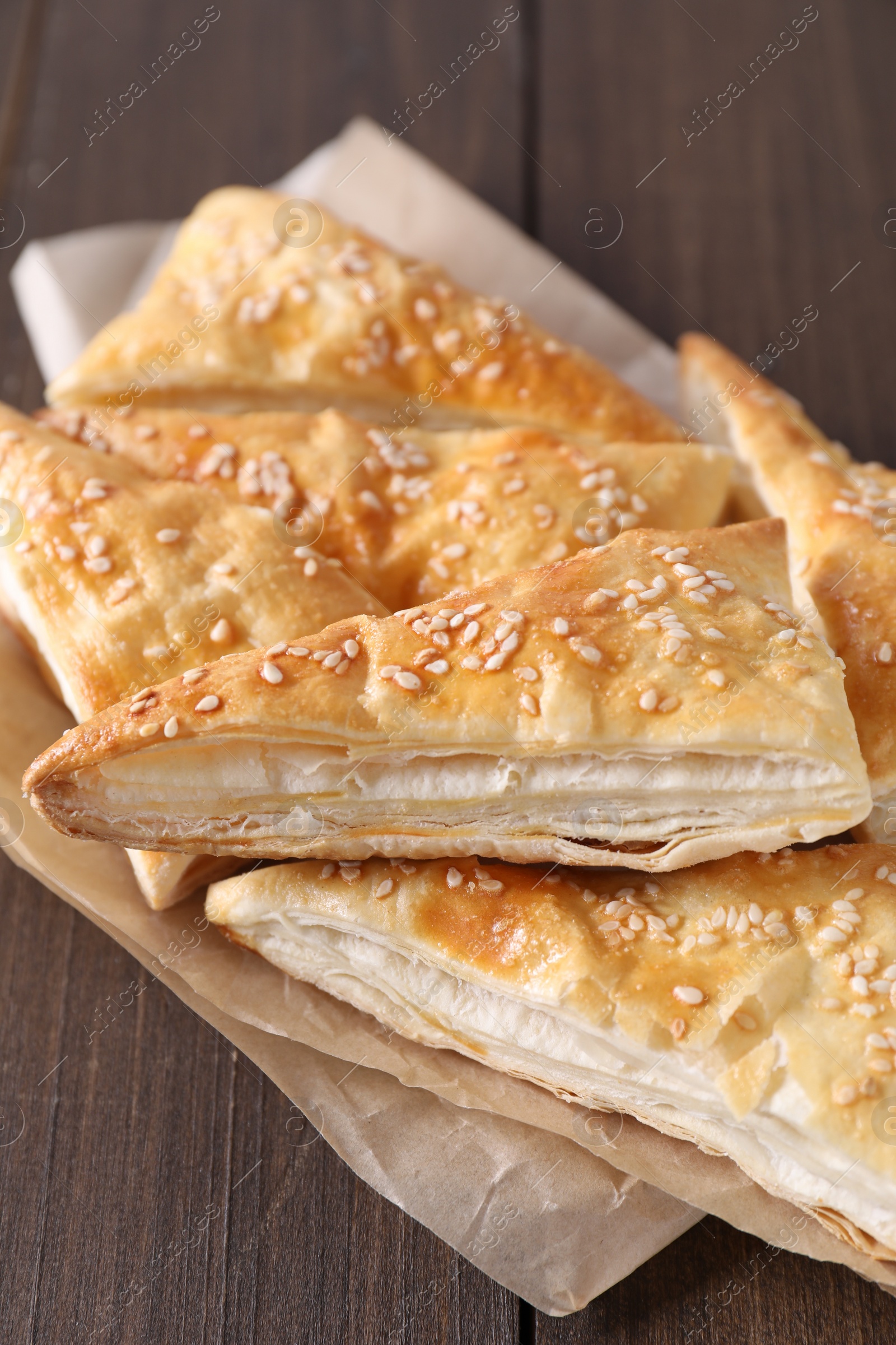 Photo of Delicious puff pastry on wooden table, closeup