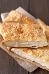 Delicious puff pastry on wooden table, closeup