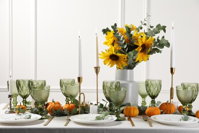 Photo of Beautiful autumn table setting with bouquet indoors. Plates, cutlery, glasses and floral decor